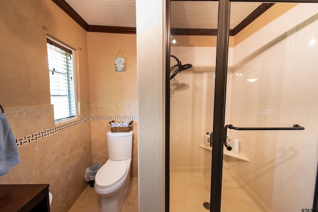 bathroom featuring tile walls, a shower with door, crown molding, a textured ceiling, and toilet