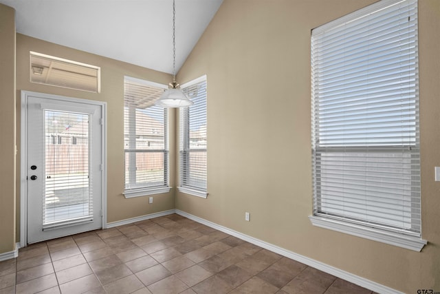 unfurnished room featuring lofted ceiling and tile patterned flooring