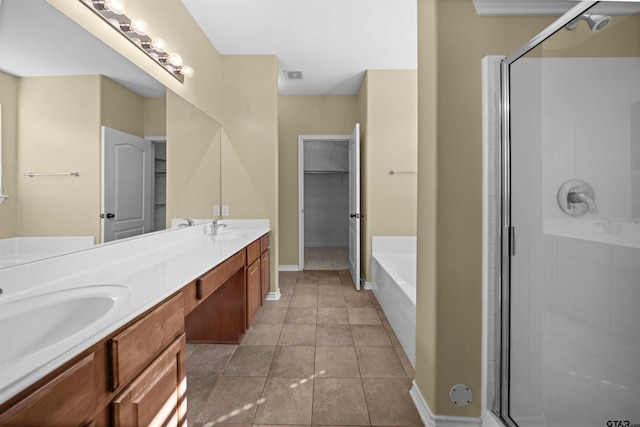 bathroom featuring tile patterned flooring, plus walk in shower, and vanity