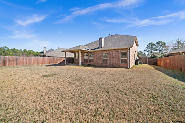 back of property featuring a lawn