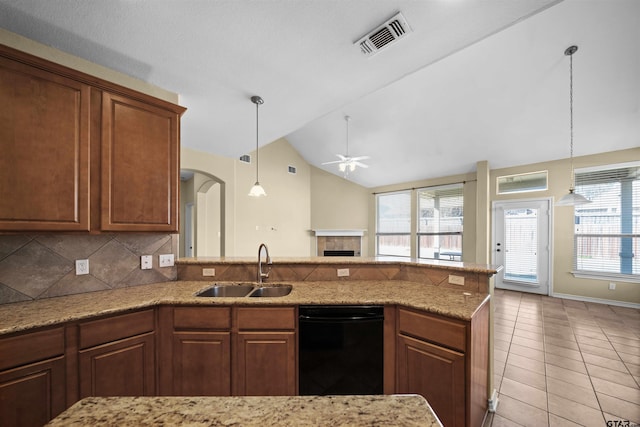 kitchen with light tile patterned flooring, lofted ceiling, sink, decorative backsplash, and ceiling fan