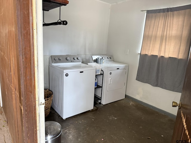 laundry room with baseboards and washer and clothes dryer