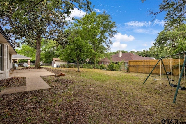 view of yard with a playground, a fenced backyard, and a patio area