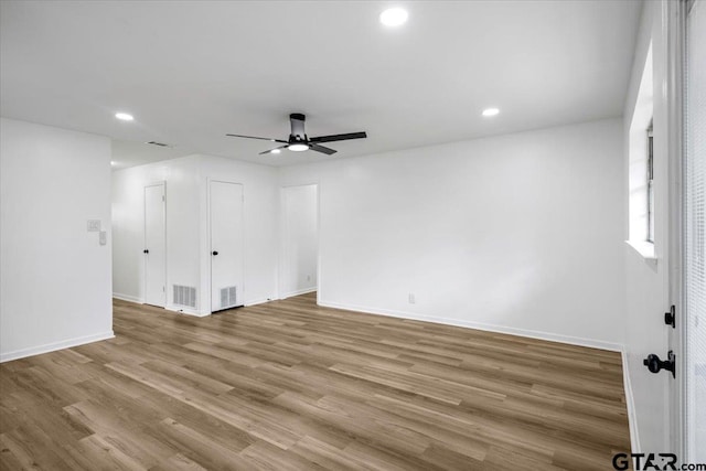 spare room with baseboards, a ceiling fan, recessed lighting, and wood finished floors