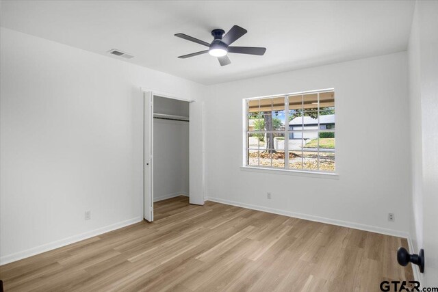 unfurnished bedroom with light wood-type flooring, baseboards, and visible vents