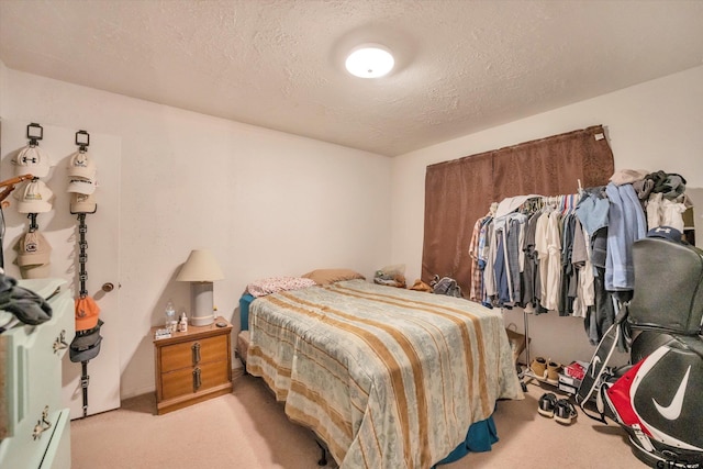 12411 Drifting Winds Dr, Houston, TX 77044 - bedroom featuring light colored carpet and a textured ceiling
