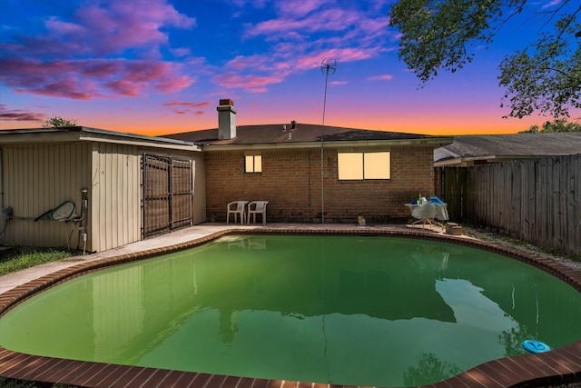 12411 Drifting Winds Dr, Houston, TX 77044 - view of pool at dusk