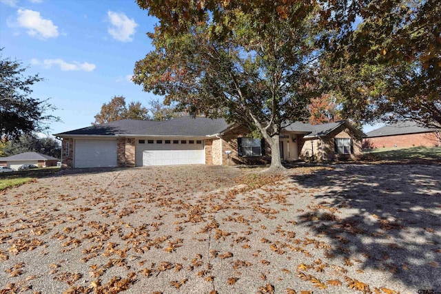 ranch-style home with a garage and driveway