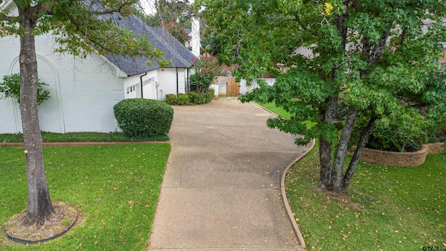 view of property exterior with a yard