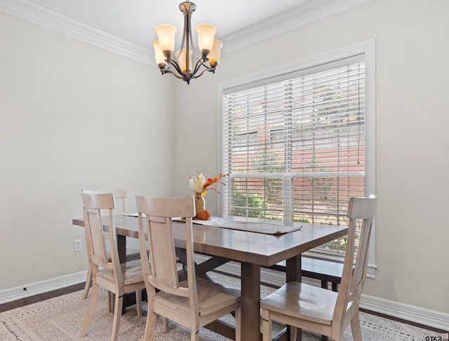 dining room featuring a wealth of natural light, wood-type flooring, a chandelier, and crown molding