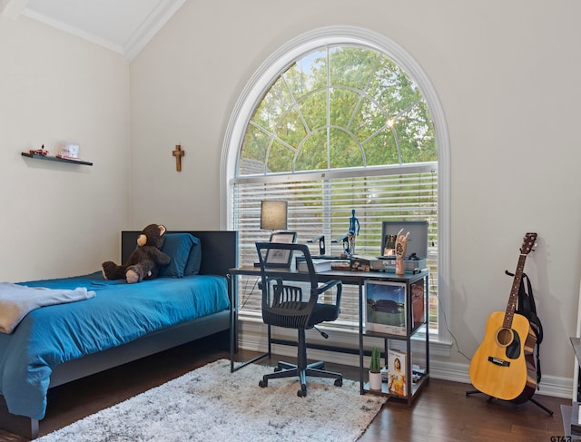 bedroom with dark hardwood / wood-style flooring and ornamental molding