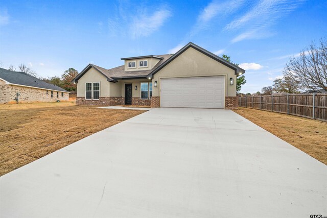 view of front facade with a garage and a front lawn