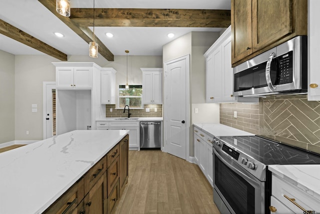 kitchen with white cabinets, beamed ceiling, pendant lighting, and appliances with stainless steel finishes