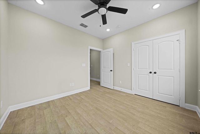 unfurnished bedroom featuring a closet, ceiling fan, and light hardwood / wood-style flooring