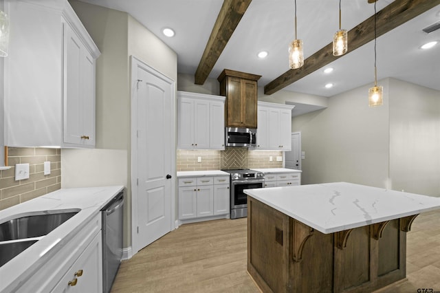 kitchen featuring white cabinets, light hardwood / wood-style flooring, beamed ceiling, a breakfast bar, and appliances with stainless steel finishes