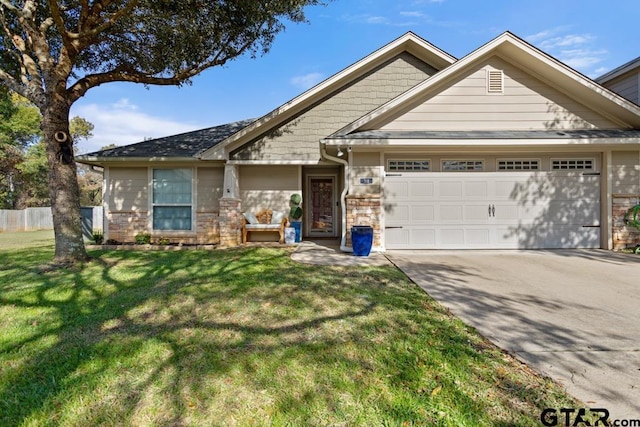 view of front of house featuring a front yard and a garage