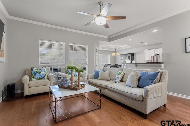 living room with wood-type flooring, ceiling fan, and crown molding