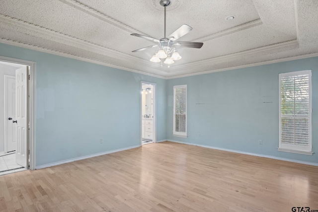 spare room featuring a textured ceiling, light hardwood / wood-style flooring, ceiling fan, and crown molding