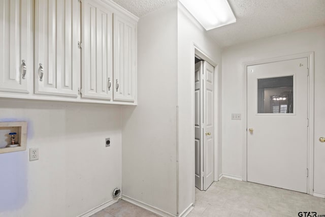 laundry area featuring cabinets, electric dryer hookup, a textured ceiling, and hookup for a washing machine