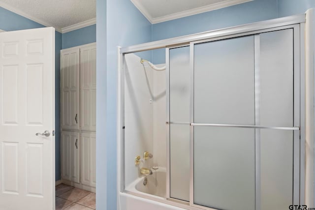 bathroom featuring combined bath / shower with glass door, a textured ceiling, tile patterned flooring, and crown molding