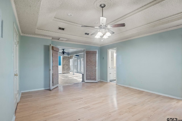 unfurnished room featuring ornamental molding, light hardwood / wood-style floors, a textured ceiling, and ceiling fan