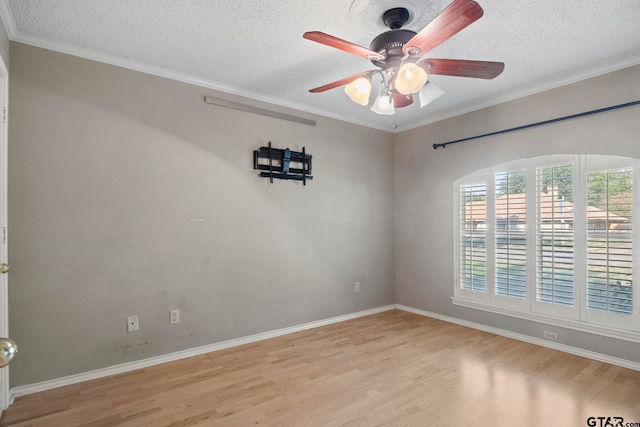 unfurnished room featuring ceiling fan, a textured ceiling, light hardwood / wood-style flooring, and crown molding