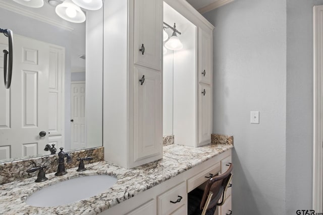 bathroom featuring vanity and crown molding