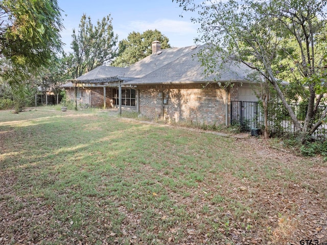 rear view of property featuring a lawn