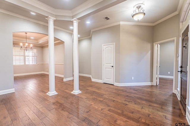 interior space with a notable chandelier, dark hardwood / wood-style floors, and ornamental molding