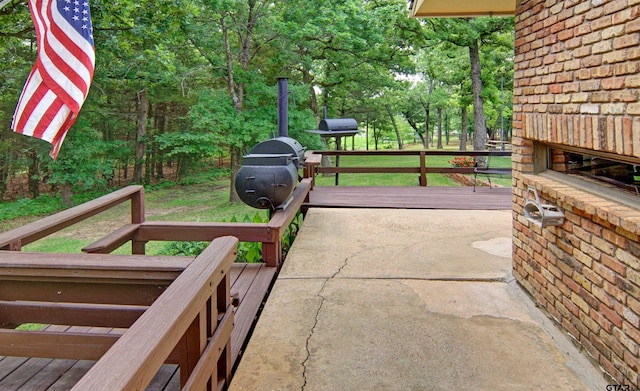 view of patio with a wooden deck and area for grilling