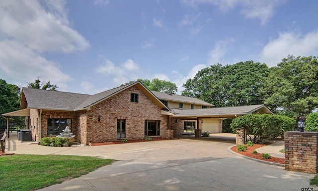 view of front of house featuring cooling unit and a garage