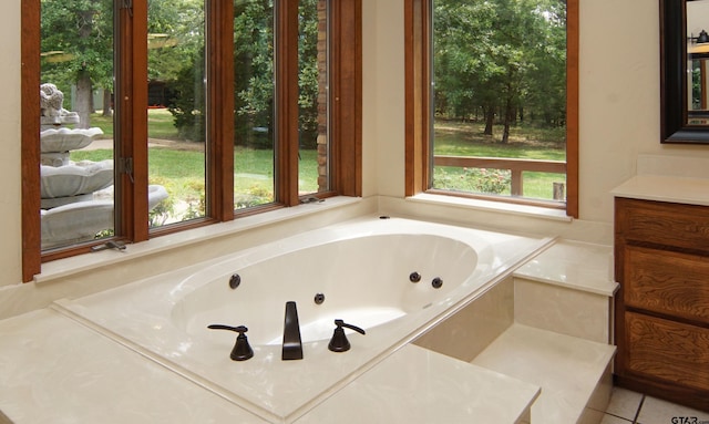 bathroom with plenty of natural light, vanity, a bath, and tile patterned flooring