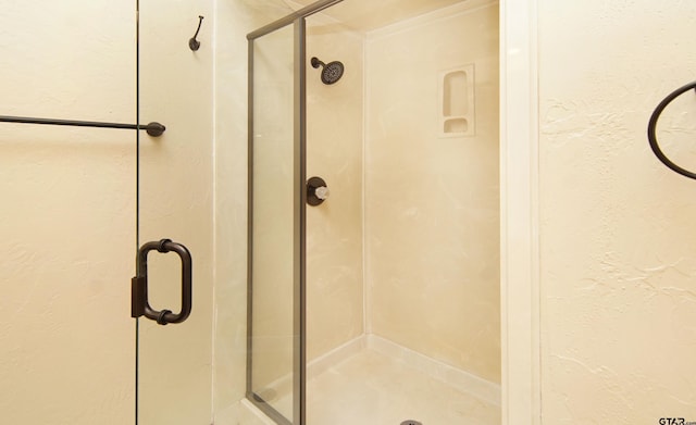 bathroom with a shower with door