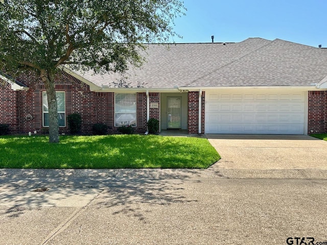 1521 Rice Rd Unit Z103, Tyler, TX 75703 - view of front of home with concrete driveway, a garage, brick siding, roof with shingles, and a front yard