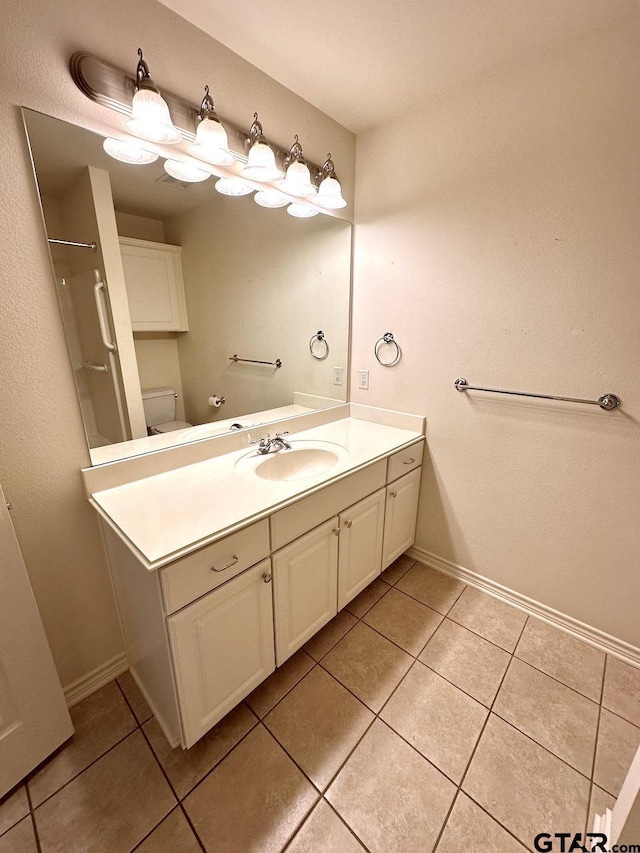 1521 Rice Rd Unit Z103, Tyler, TX 75703 - bathroom featuring tile patterned flooring, vanity, toilet, and baseboards