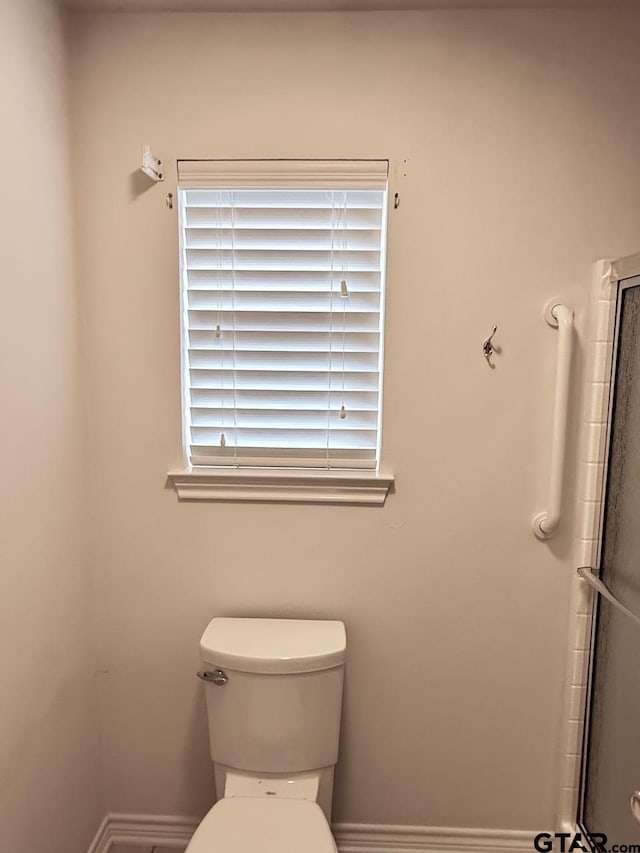 1521 Rice Rd Unit Z103, Tyler, TX 75703 - bathroom featuring toilet and baseboards