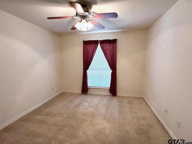 1521 Rice Rd Unit Z103, Tyler, TX 75703 - spare room featuring a ceiling fan, light carpet, and baseboards