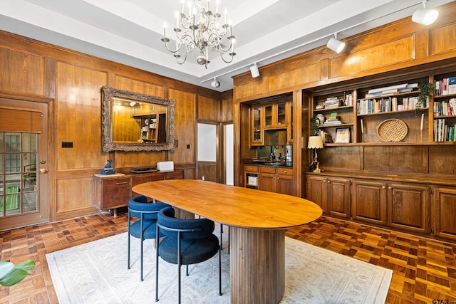6307 Shady Oaks Dr, Tyler, TX 75703 - dining area featuring a chandelier and wooden walls