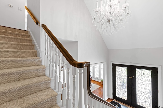 6307 Shady Oaks Dr, Tyler, TX 75703 - stairs with high vaulted ceiling, a chandelier, french doors, and wood finished floors