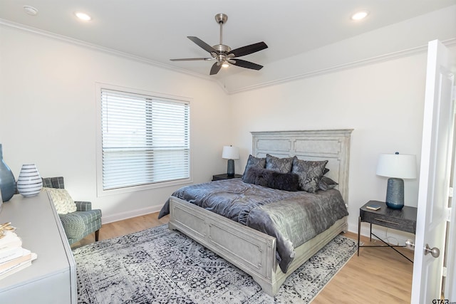 bedroom featuring ornamental molding, light wood-type flooring, and ceiling fan