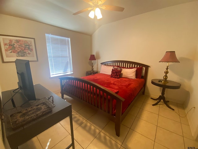 tiled bedroom featuring ceiling fan