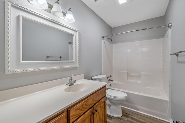 full bath featuring toilet, shower / bath combination, wood finished floors, visible vents, and vanity