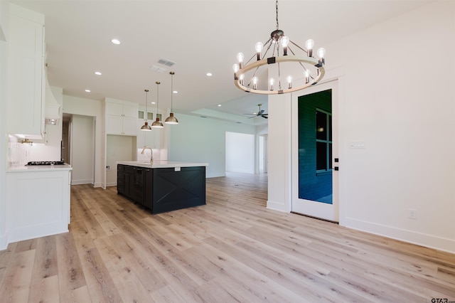 kitchen with white cabinets, light countertops, recessed lighting, open floor plan, and light wood-type flooring