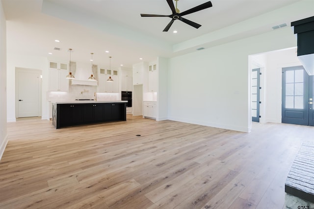unfurnished living room with visible vents, a ceiling fan, light wood finished floors, and recessed lighting