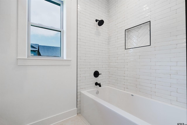 bathroom with baseboards and  shower combination