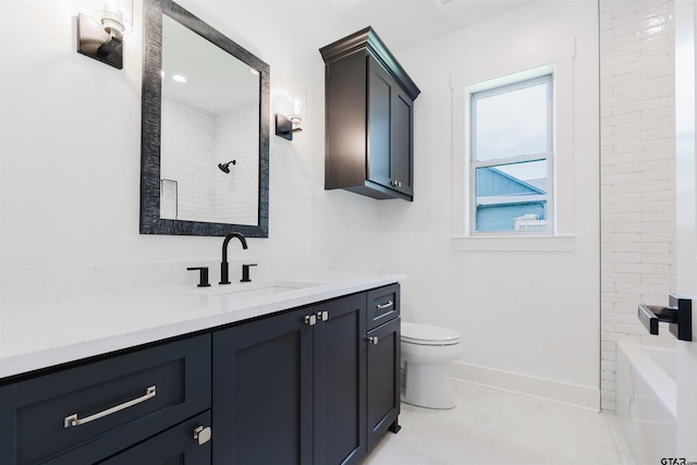 bathroom with vanity, baseboards, and toilet