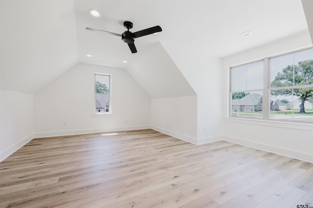 bonus room featuring lofted ceiling, baseboards, recessed lighting, a ceiling fan, and light wood-style flooring