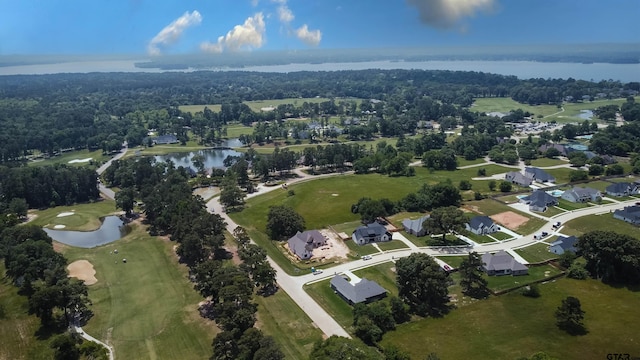 drone / aerial view with a water view, view of golf course, and a residential view