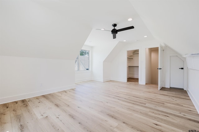 additional living space featuring baseboards, a ceiling fan, light wood finished floors, and lofted ceiling