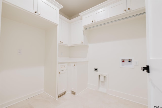 clothes washing area with electric dryer hookup, washer hookup, cabinet space, and baseboards